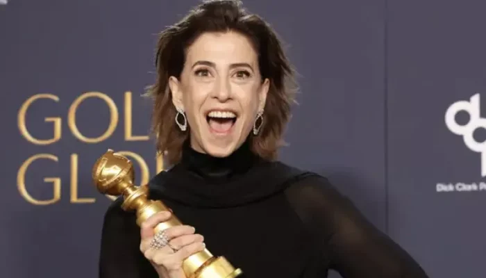 Fernanda Torres segurando o troféu do Globo de Ouro em cena emocionada